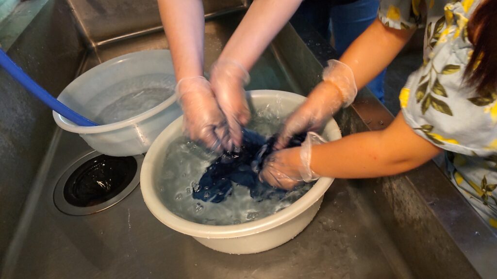A mother and a child washing cloth in Chogen no Sato Village